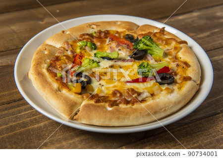 Pizza placed on the table Pizza placed on the table 90734001