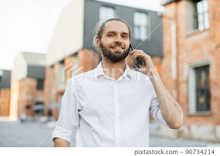 Portrait of smiling young man doing a phone call. 90734214