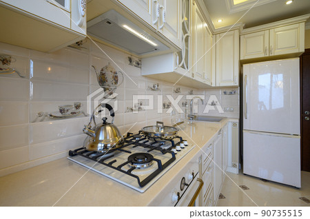 Details of classic white and beige kitchen in studio apartment Details of classic white and beige kitchen in studio apartment 90735515