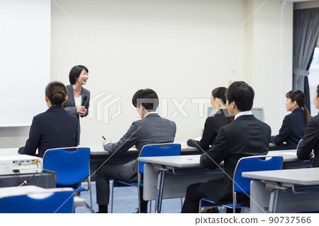 Men and women in suits taking seminars Men and women in suits taking seminars 90737566
