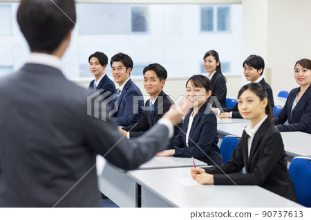 Men and women in suits taking seminars 90737613