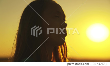 religion way life. child's face against background sunset sky. portrait teenager looking up. girl thinks dreaming. concept children dream. youthful silhouette child girl. daughter asks achieve dream. religion way life. child's face against background sunset sky. portrait teenager looking up. girl thinks dreaming. concept children dream. youthful silhouette child girl. daughter asks achieve dream. 90737682