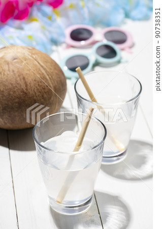 Drink natural coconut juice with a straw Drink natural coconut juice with a straw 90738351