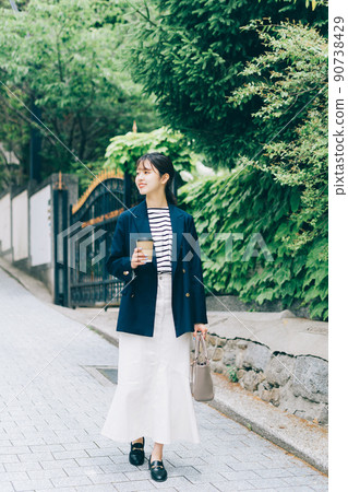 A young lady walking in the city A young lady walking in the city 90738429