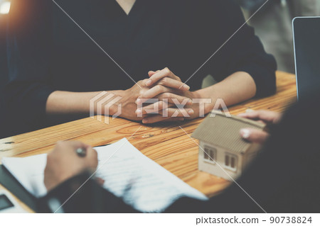 Real Estate Agent explain insurance and agreement contract to client before sign contract. Real Estate Agent explain insurance and agreement contract to client before sign contract. 90738824