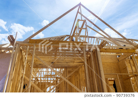 Framing of beams stick built house on new home under construction 90739376