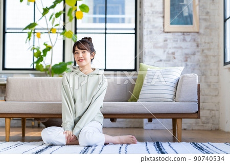 Young woman relaxing in the living room Young woman relaxing in the living room 90740534