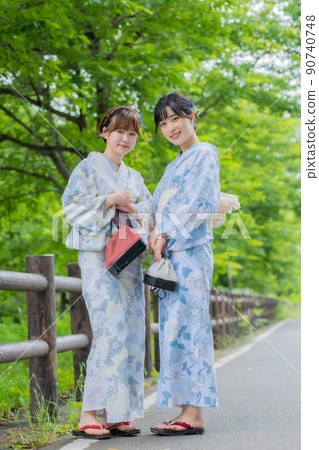 Portrait of a young woman in a yukata with a fresh green background Portrait of a young woman in a yukata with a fresh green background 90740748
