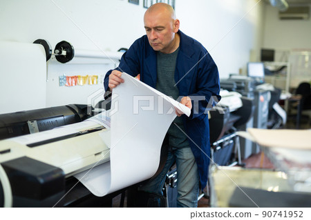 Man working in publishing facility 90741952