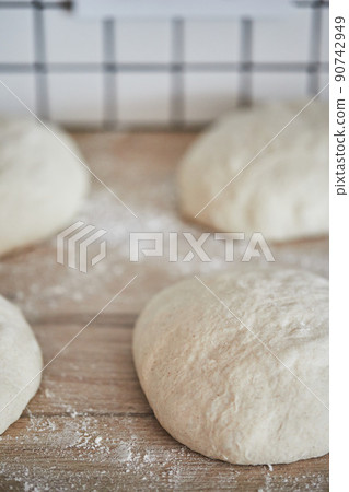 The process of making wheat bread at home. Dough shaping. The concept of healthy homemade food. Vertical photo. The process of making wheat bread at home. Dough shaping. The concept of healthy homemade food. Vertical photo. 90742949