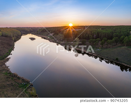 Beauriful sunset view along the Iset river and rocks near Kamensk-Uralskiy. A scenic sunset at the river. Kamensk-Uralskiy, Sverdlovsk region, Ural mountains, Russia. Aerial view 90743205