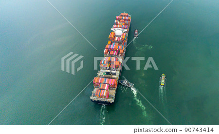 Arial view by drone camera transportation logistics and container dock cargo yard with working crane bridge in shipyard with transport logistic import export with blue sky background. 90743414