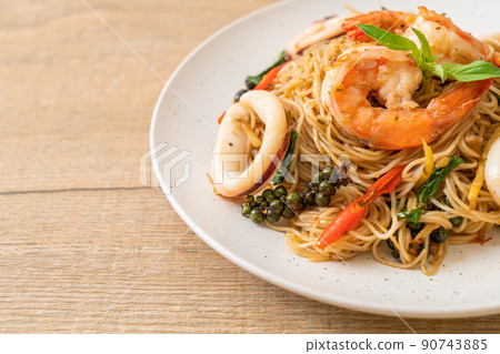 stir-fried Chinese noodle with basil, chilli, shrimps and squid 90743885