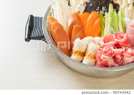 Budae Jjigae or Budaejjigae (Army stew or Army base stew). It is loaded with Kimchi, spam, sausages, ramen noodles and much more Budae Jjigae or Budaejjigae (Army stew or Army base stew). It is loaded with Kimchi, spam, sausages, ramen noodles and much more 90743942
