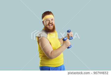 Funny happy bearded chubby man having fun during his sports workout with dumbbells 90744652