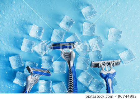 Refreshing shaving machines for the face against the background of frosty ice cubes Refreshing shaving machines for the face against the background of frosty ice cubes 90744982