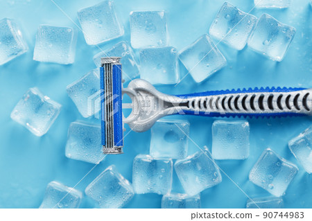 Refreshing shaving machines for the face against the background of frosty ice cubes 90744983