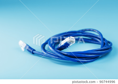 Blue Ethernet Cable Cord Patch cord on a blue background with free space 90744996