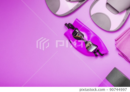 Equipment for swimming in the pool and in the sea on a pink background 90744997
