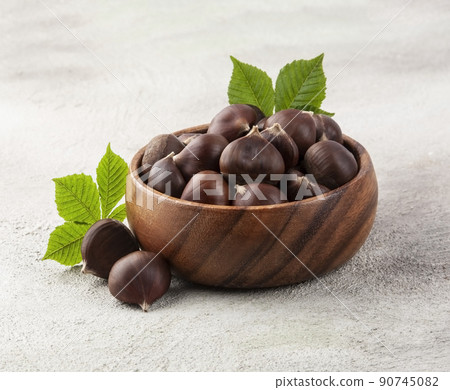 chestnut in wooden plate close up chestnut in wooden plate close up 90745082