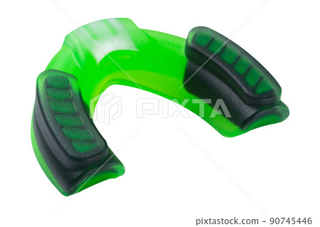green silicone boxing mouth guard for one jaw, lies with the reverse side, on a white background green silicone boxing mouth guard for one jaw, lies with the reverse side, on a white background 90745446
