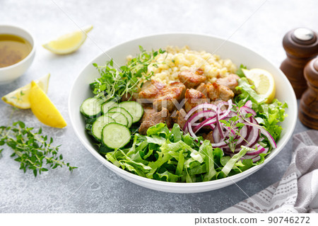 Pork kebab bulgur salad bowl with cucumber, lettuce, thyme and mustard sauce Pork kebab bulgur salad bowl with cucumber, lettuce, thyme and mustard sauce 90746272