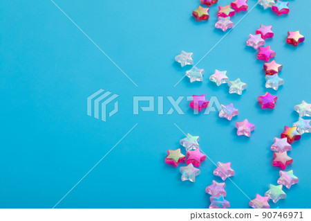 Star beads spilling on a light blue background star 90746971