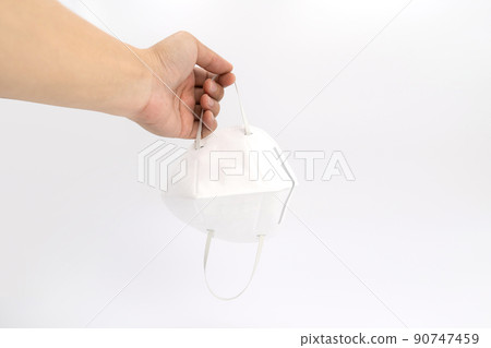 Asian man hand holds white clear pm 2.5 mask in studio light on white background. 90747459