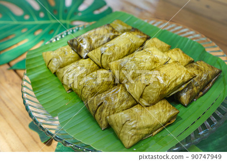 Khao tom mad or steamed mung bean with sticky rice is the local and trandition Thai dessert. It's wraped by banana leaf. Khao tom mad or steamed mung bean with sticky rice is the local and trandition Thai dessert. It's wraped by banana leaf. 90747949