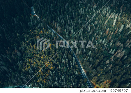 Aerial view of curvy road passing through the green forest, top view Aerial view of curvy road passing through the green forest, top view 90749707