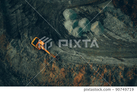 bright excavator at work on a dark background view from a drone 90749719