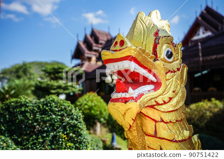 Asia gold red lion statue with temple background. 90751422