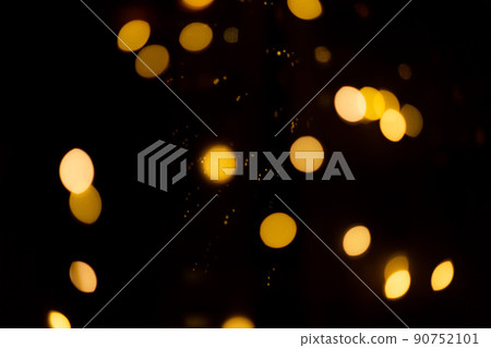 black background with golden glittering lights bokeh. abstract defocused pattern black background with golden glittering lights bokeh. abstract defocused pattern 90752101