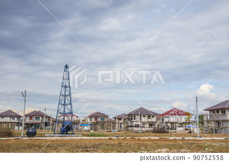 Residential new house building at construction site with clouds and blue sky Residential new house building at construction site with clouds and blue sky 90752558