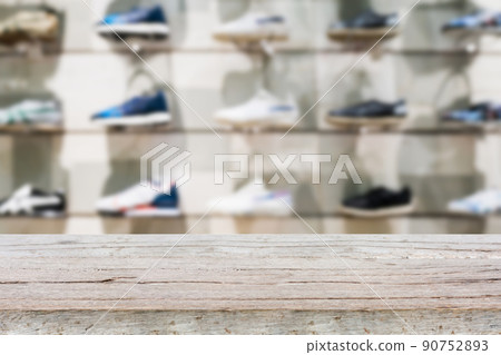Wood table top with Shoes on shelves in the shoes store 90752893