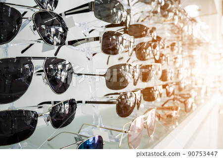 Sunglasses on shelves in glasses store 90753447
