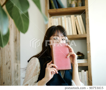 Young woman relaxing while reading in an antique room 1 90753815