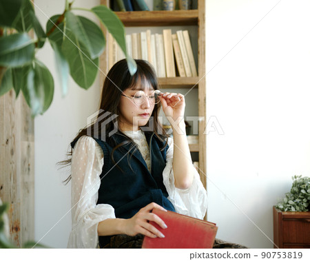 Young woman relaxing while reading in an antique room 5 Young woman relaxing while reading in an antique room 5 90753819