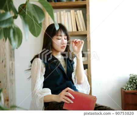 Young woman relaxing while reading in an antique room 6 Young woman relaxing while reading in an antique room 6 90753820