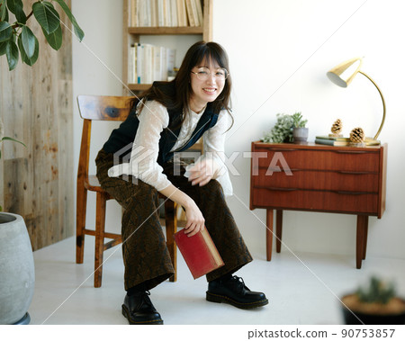 Young woman relaxing while reading in an antique room 37 90753857