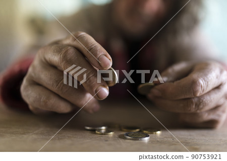 Senior man with dirty hands counting coins 90753921