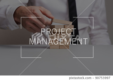 Project management text over businessman building a tower of wooden pegs 90753997