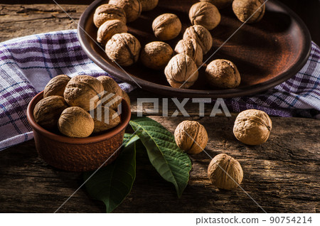 Walnut kernels on a dark table with a colored background 90754214