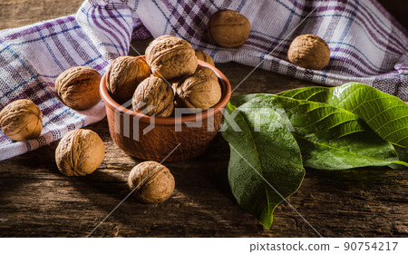 Walnut kernels on a dark table with a colored background Walnut kernels on a dark table with a colored background 90754217
