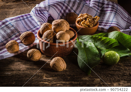 Walnut kernels on a dark table with a colored background Walnut kernels on a dark table with a colored background 90754222