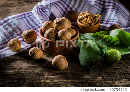 Walnut kernels on a dark table with a colored background Walnut kernels on a dark table with a colored background 90754223