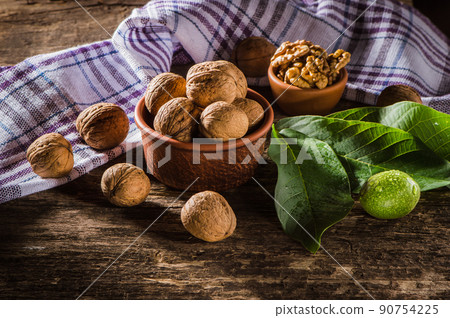 Walnut kernels on a dark table with a colored background Walnut kernels on a dark table with a colored background 90754225