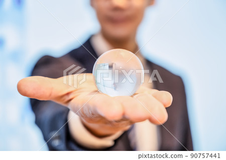 A businessman with an earth crystal 90757441