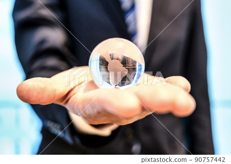 A businessman with an earth crystal 90757442