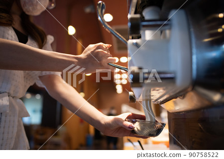Women's hands serving soft serve ice cream 90758522